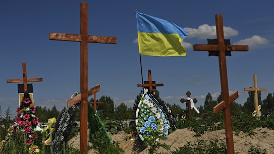 WAR CRIMES. HOLD FOR DAN ADAMS APPROVAL
The Ukrainian flag flies above the graves at the new cemetery in Bucha. Over 1300 civilians in Bucha and surrounds were killed by Russian soldiers when they occupied the town 30km northwest of Kyiv. Russian forces committed a litany of apparent war crimes during their occupation from March 4th to 31st. According to Human Rights Watch there is evidence of summary executions, other unlawful killings, enforced disappearances, rape and torture. The laws of war prohibit wilful and indiscriminate killing, torture, enforced disappearances, and inhumane treatment of captured combatants and civilians in custody. Anyone who orders, or deliberately commits such acts, or aids and abets them, is responsible for war crimes. Bucha,   Ukraine. 23rd June, 2022. Photo: Kate Geraghty