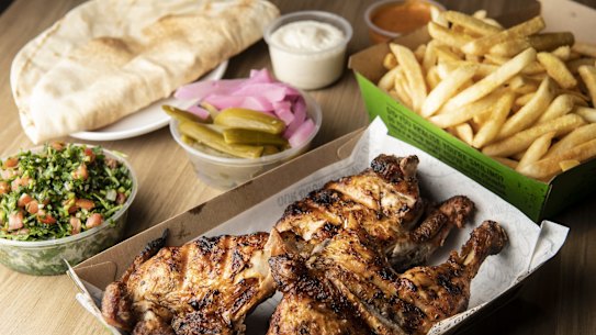 The essentials: whole charcoal chicken meal with Lebanese pickles, bread, tabouli, garlic dip, and fries.