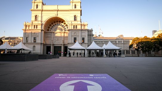People queue to receive the COVID-19 vaccine at the vaccination hub at the Royal Exhibition Building in Carlton. 