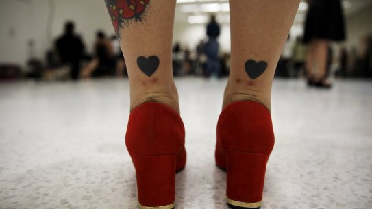 The legs of a model tattooed with hearts as she prepares backstage before a presentation as part of Fashion Weekend Plus Size Summer 2015 collection show in Sao Paulo July 25, 2015. REUTERS/Nacho Doce