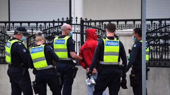 Police detain then release a man near the George Andrews Reserve,  Dandenong last week. 