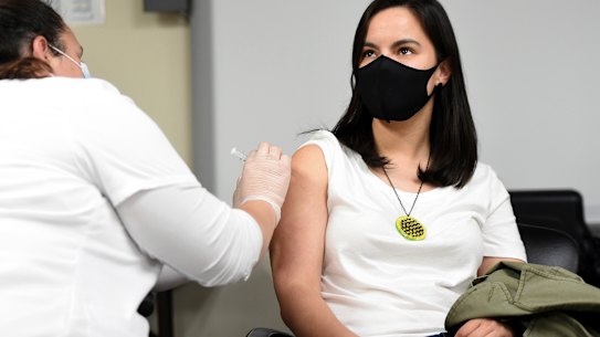 Woman gets her second dose of the Moderna vaccine from a student nurse in Pittsburgh.
