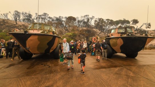 The Age , News, 03/01/2020, photo by Justin McManus.
Mallacoota fires. People stranded in Mallacoota after the bushfires that ravaged the townon December 30 are evacuated by army personel to the HMAS Choules.