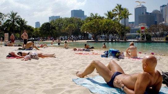 Swimmers and sunbakers enjoy the hot weather at South Bank.