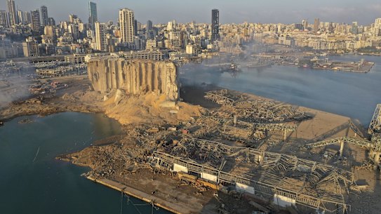 A drone picture shows the scene of an explosion that hit the seaport of Beirut, Lebanon, Wednesday, Aug. 5, 2020. A massive explosion rocked Beirut on Tuesday, flattening much of the city's port, damaging buildings across the capital and sending a giant mushroom cloud into the sky. (AP Photo/Hussein Malla)