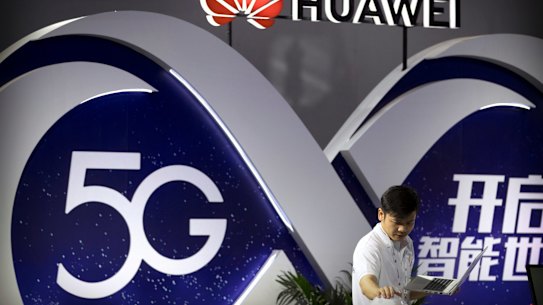 A staff member uses a laptop computer at a display for Huawei 5G wireless technology at the PT Expo in Beijing.