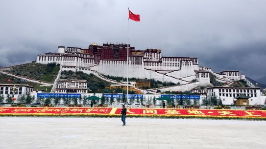 The Chinese flag flies over the Potala Palace in Lhasa, Tibet. 