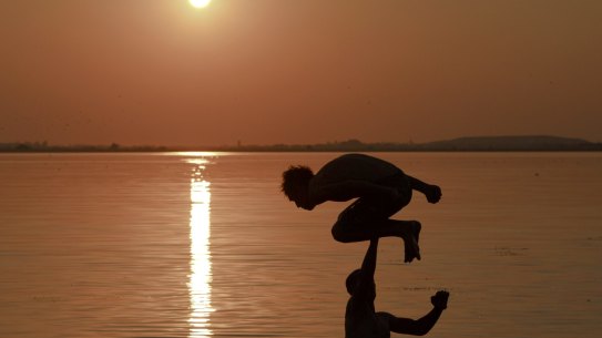 A man jumps into a lake in Bucharest, Romania during a heatwave in July 2015: global temperatures are now about 1.1 degrees warmer than the pre-industrial era and are on track to be more than 3 degrees warmer by the end of this century if carbon emissions are not curbed, the World Meteorological Organization warns.