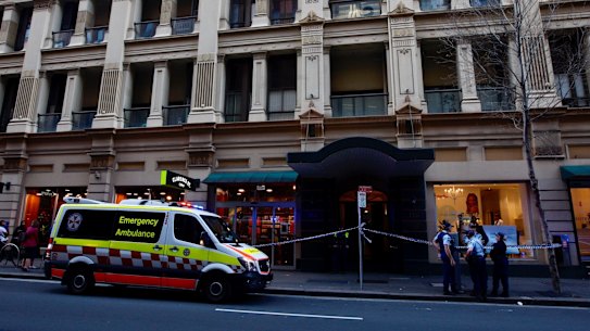 An unidentified man exits 118 Clarence Street after informing police that he had heard screams of a woman from inside the apartment building. 