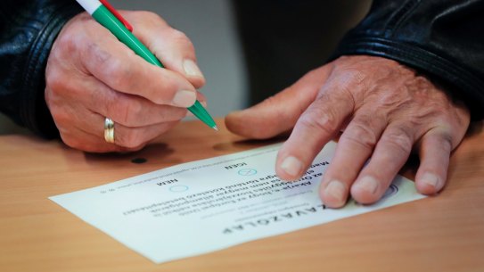 FILE - In this Oct. 2, 2016 file photo a man marks a ballot paper to vote against Hungarian Prime Minister Viktor Orban's policies on migrants in the referendum in Budapest, Hungary, Sunday, Oct. 2, 2016. Orban?s Fidesz party failed Tuesday, Nov. 8, 2016 to secure any opposition support on future plans by the European Union to resettle asylum seekers among members of the bloc and fell two votes short of the two-thirds majority necessary in today's vote. (AP Photo/Vadim Ghirda, file)