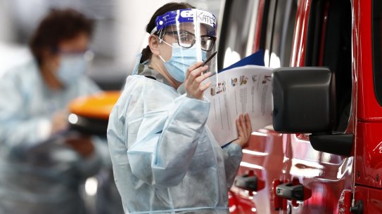 MELBOURNE, AUSTRALIA - JUNE 29: A member of the ADF (Australian Defence Force) administers a COVID-19 test at Melbourne Showgrounds on June 29, 2020 in Melbourne, Australia. Victoria has recorded 75 new coronavirus cases overnight, the state's fourth-highest single day rise since the start of the pandemic, while increased testing in Melbourne suburbs that have been identified as community transmission hotspots for coronavirus continues. Restrictions in Victoria have been tightened in response to the spike in new cases across the state with premier Daniel Andrews extending the current state of emergency for at least four weeks to allow police the power to enforce social distancing rules. (Photo by Darrian Traynor/Getty Images)