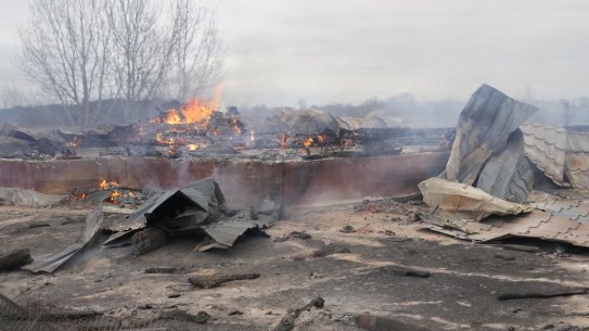 Smoke and flame rise from the debris of a privet house in the aftermath of Russian shelling outside Kyiv, Ukraine, on Thursday.