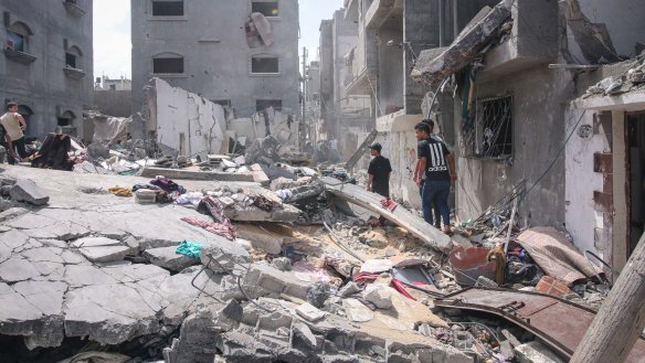 Palestinians inspect the rubble of a building after an Israeli airstrike in central Gaza last month.