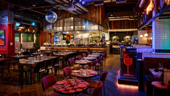 The new restaurant has a disco ball and a disco ball-shaped DJ booth.