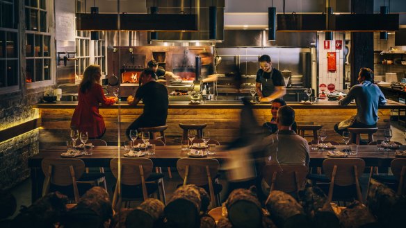 The dining room at Surry Hills restaurant Firedoor, with head chef Lennox Hastie in the kitchen.