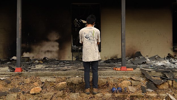 Balmoral resident Gabriel aged 16 looks into what was his bedroom at his home. It was destroyed by fire on December 21.