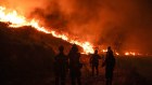 Firefighters attempt to control a wildfire in Dionysos, Greece, on Monday.