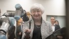 Janet Yellen engages with a robotic arm at the Mesa Community College in Arizona. 
