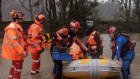 Lansvale residents Jack and Jamarcus, along with their pets are evacuated by the NSW SES Kogarah Unit as flood waters rise along the Georges River on July 3, 2022.