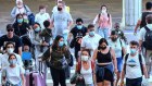 Travellers wearing protective face masks arrive at Orlando International Airport in Florida in 2021.