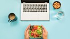 Healthy business lunch in the office, salad for snack, glass of water, almonds, cup of coffee on blue table. Top view with copy space. Concept proper nutrition. Lunchbox. Take away. Desk lunch
iStock