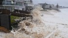 Sea foam whipped up by the strong powerful surf begins to inundated properties along Collaroy. 10th February 2020. Photo: Nick Moir