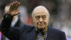 Mohamed Al Fayed waves to the crowd at an English Premier League soccer match in 2008.