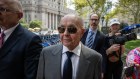 Joe Lewis, owner of Tottenham Hotspur Football Club, center, leaves court in New York in July.
