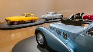 Inside the Sculpture room at Motion. Autos, Art, Architecture, from left: the Pegaso Z-102 Cúpula; a 1953 Bentley R-Type Continental; and the blue nose of the Bugatti Type 57S Atlantic.