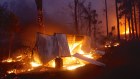 Photographs shows burning properties in Rainbow Flat on Friday night after fire from the Hillville Fire broke containment lines.