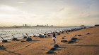 Point of tension. Buildings in Xiamen on mainland China across the Taiwan Strait from anti-landing barriers on a beach in Kinmen, Taiwan. 