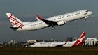 A Virgin Australia aircraft lands at Sydney Airport. 