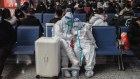 Travellers wearing protective gear at Jinan West Railway Station in Jinan, Shandong province, China.