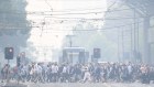 Commuters in Melbourne confront severe smoke haze on Tuesday. 