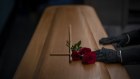 A mortuary worker prepares the coffin carrying the body of a person who died of COVID-19 before being cremated during a funeral at MÃ©mora mortuary in Girona, Spain, Thursday, Nov. 19, 2020. (AP Photo/Emilio Morenatti)