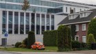 Looming presence: Residential housing beside the ASML Holding NV global headquarters in Veldhoven, Netherlands.