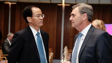 Chinese Ambassador to Australia, Cheng Jingye, speaks with John Brumby, president of the ACBC, during the Australia China Business Council (ACBC) networking day at Parliament House in Canberra.