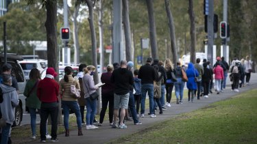 People wait in line at the mass vaccination centre at Sydneyâ€™s Olympic Park this week. 