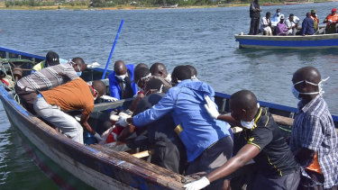 Rescuers retrieve a body from the water near Ukara Island in Lake Victoria, Tanzania.