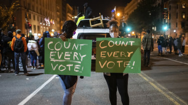Demonstrators get their message across in Washington as the US waits for a result from the presidential election.