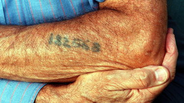 Dario Gabbai shows the tattoo of  his Auschwitz number on his arm (1999).