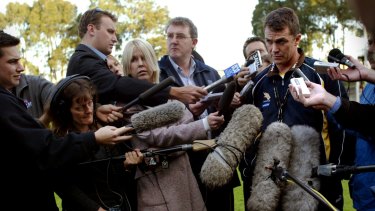 Peter Schwab is surrounded by the media when coaching Hawthorn.
