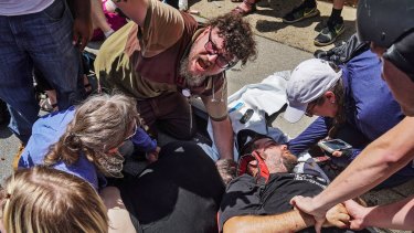 Responders work with victims at the scene where James Alex Fields jnr plowed a car into a crowd of protesters in Charlottesville in August 2017.