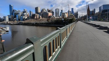 A deserted Princes bridge in Melbourne during the stage four lockdown. Treasurer Josh Frydenberg calculates the shutdown will cost the economy $1 billion a week.