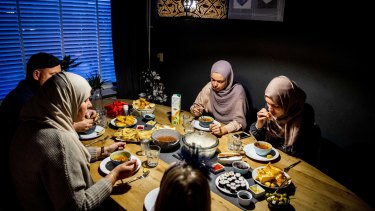 A family eat at the table during the iftar, the meal after sunset during the Islamic fasting month of Ramadan in Rotterdam, The Netherlands.