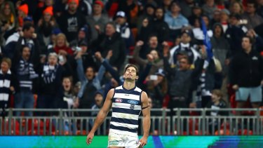 Tom Hawkins reacts after kicking a behind on the final siren to draw the match.