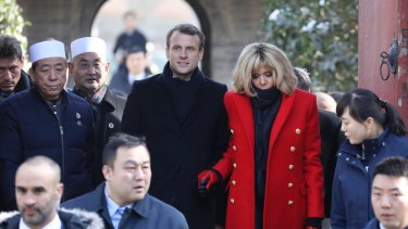 French President Emmanuel Macron, centre, and his wife Brigitte Macron, in red, visit the Great Mosque of Xian during a visit to the Great Mosque of Xian in northwestern China in 2018.