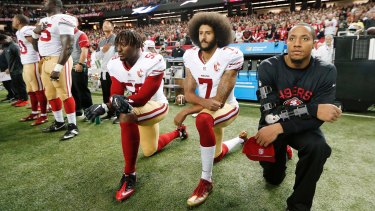 Former San Francisco 49ers quarterback Colin Kaepernick (second from right) triggered a wave of NFL players kneeling during the anthem to raise awareness of racism and social injustice. He was later dumped by the NFL.