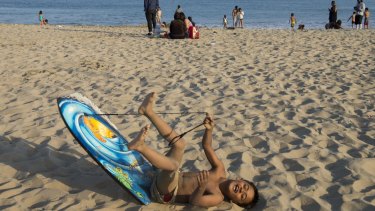 Thousands of Memorial Day beachgoers, including Gabriel Cordromp, 8, were ordered out of the water at Corona del Mar beach as authorities searched for the shark that attacked Korcsmaros the day before.
