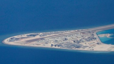 An airstrip, structures, and buildings on China's man-made Subi Reef in the Spratly chain of islands in the South China Sea are seen from a Philippine Air Force C-130 transport plane of the Philippine Air Force. 